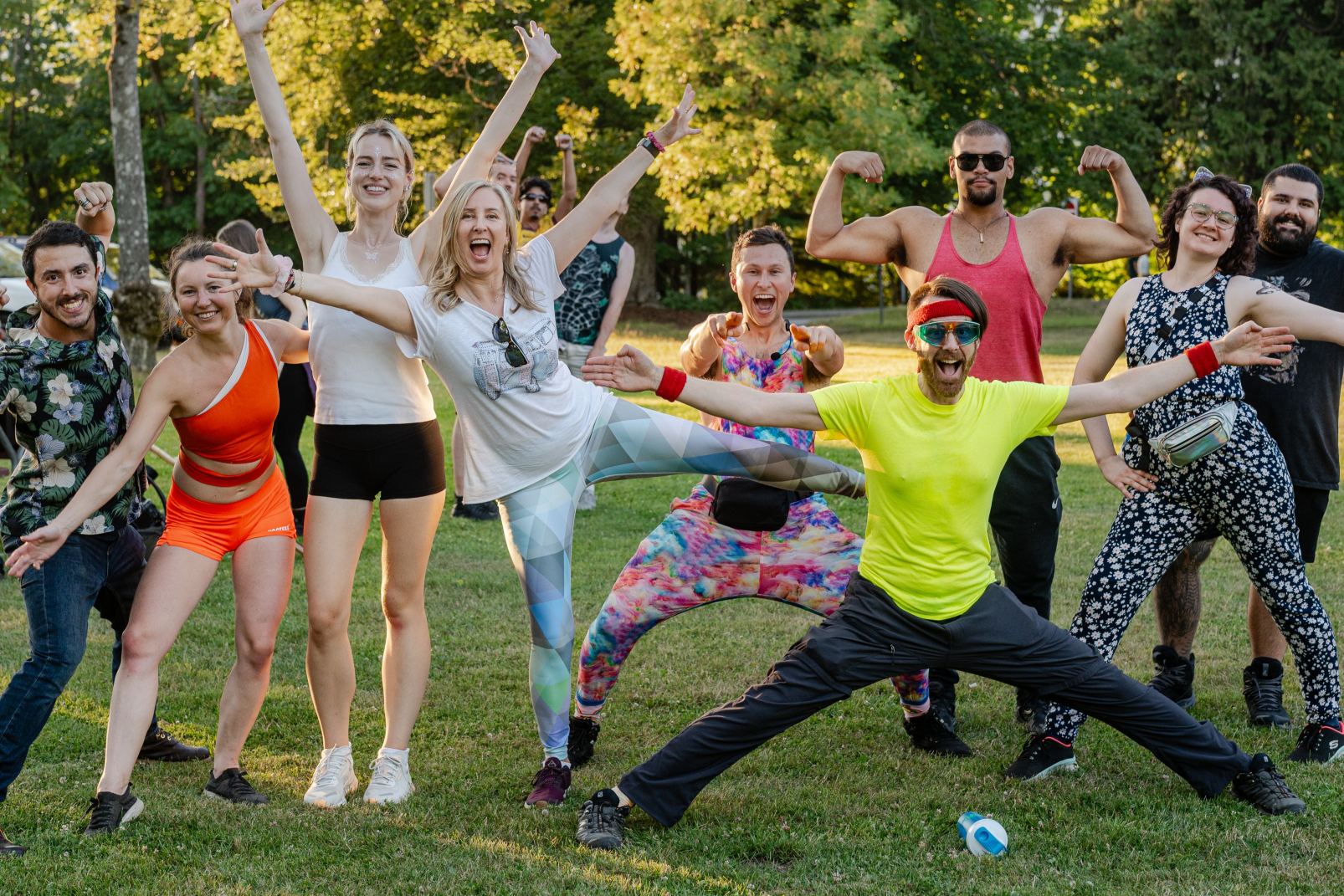 A joyful group posing together during an outdoor sober park event