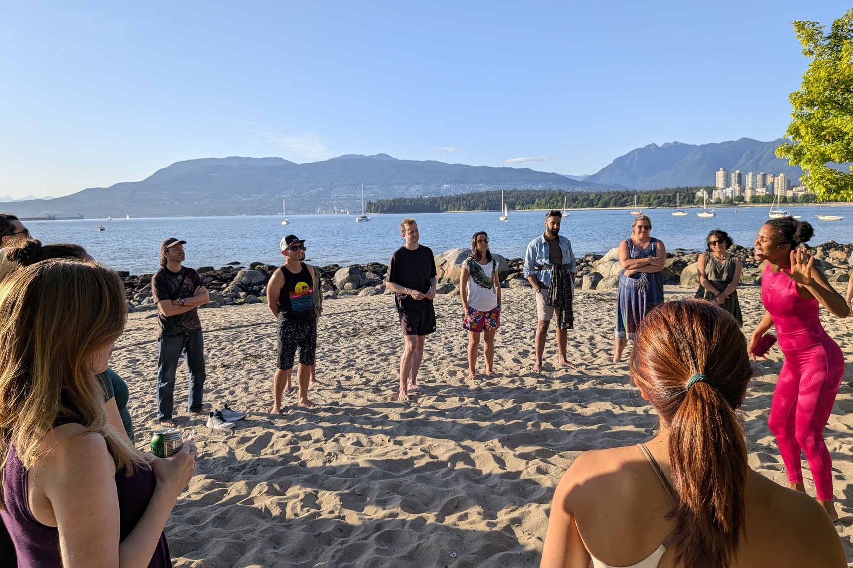 A sober social circle gathered on a Vancouver beach at sunset