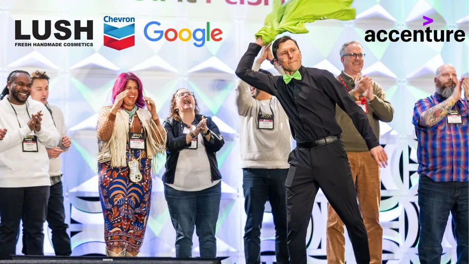 Jacques Martiquet leading an energetic group event on stage